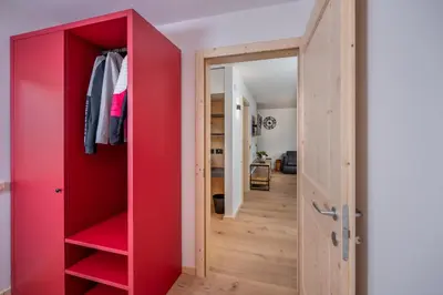 a red closet in a room with a red door at Casa Paolina - Alpine Stay Apartments in Tesero
