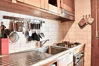 a kitchen with a stainless steel sink and utensils at Beautiful 3 bedroom flat in Cortina with car park in Cortina dʼAmpezzo