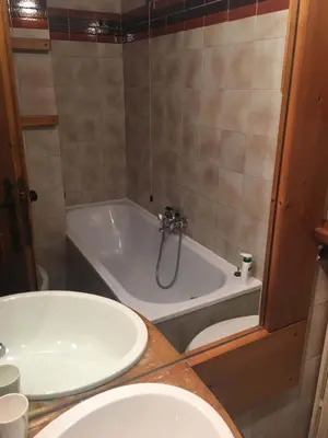 a bathroom with a tub and a toilet and a sink at Beautiful 3 bedroom flat in Cortina with car park in Cortina dʼAmpezzo