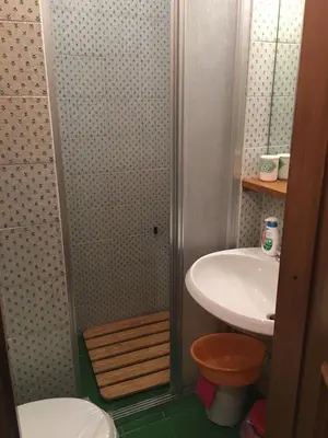 a small bathroom with a sink and a shower at Beautiful 3 bedroom flat in Cortina with car park in Cortina dʼAmpezzo
