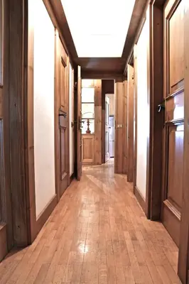 an empty hallway with wooden floors and wooden doors at Beautiful 3 bedroom flat in Cortina with car park in Cortina dʼAmpezzo