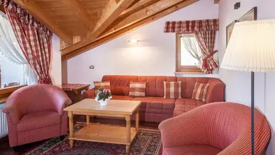 a living room with a couch and two chairs and a table at Residence Carin in Selva di Val Gardena