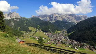 a small town in a valley in the mountains at Residence Carin in Selva di Val Gardena