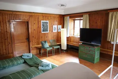 a living room with a couch and a flat screen tv at Tulpe Apartments in Vandoies di Sotto
