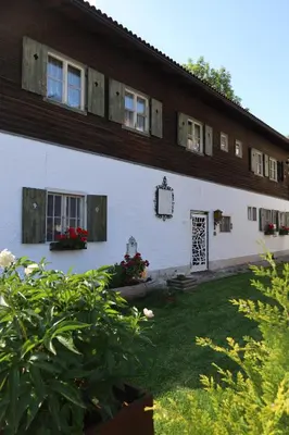a large white building with windows and a yard at Tulpe Apartments in Vandoies di Sotto