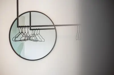 a round mirror hanging on a wall at LUXE VISTA City Apartments Algund in Lagundo
