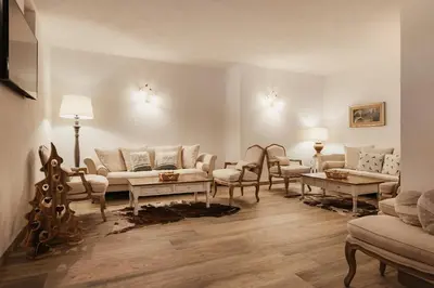 a bedroom with a bed and a table with a lamp on it at Hotel Monte Cherz in Arabba