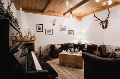 a ski lodge on a snowy mountain with a road at Hotel Monte Cherz in Arabba
