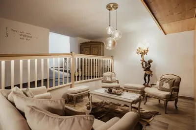 a swimming pool in a room with a table and chairs at Hotel Monte Cherz in Arabba