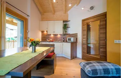 a kitchen with a large wooden table in a room at Sonngartenhof in Termeno