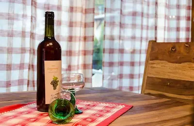 a bottle of wine sitting on a table with a glass at Sonngartenhof in Termeno