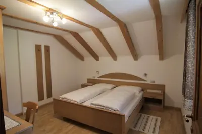 a bedroom with a bed in a room at Planhof Apartments in San Martino in Badia