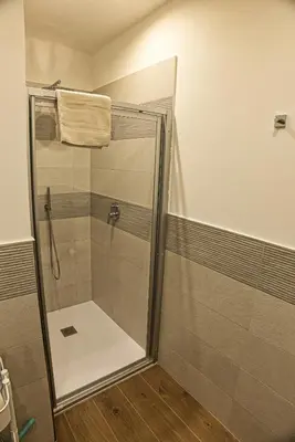 a shower with a glass door in a bathroom at Casa Giada in Bolzano