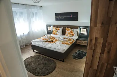 a bedroom with a bed and a large window at Casa Giada in Bolzano