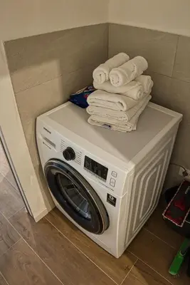 a washer and dryer with towels on top of it at Casa Giada in Bolzano