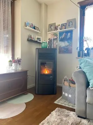 a living room with a fireplace and a couch at Alpenrösli Hafling in Avelengo
