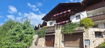 an outdoor patio with a table and chairs at Apartments Insam in Santa Cristina in Val Gardena