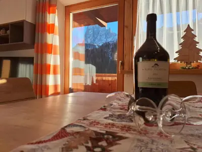 a kitchen and dining room with a table and chairs at Apartments Insam in Santa Cristina in Val Gardena