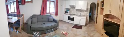 a living room with a couch and a kitchen at VILLA TERESA in San Lugano