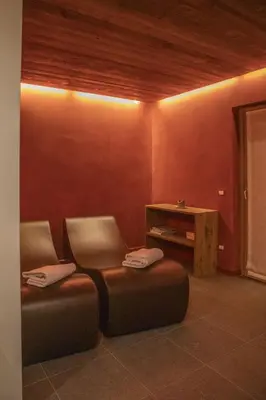 a room with two chairs and a table in it at Ca' del Sole in San Vito di Cadore