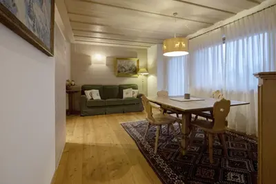 a living room with a table and a couch at Ca' del Sole in San Vito di Cadore