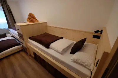 a wooden bunk bed with two pillows on it at Gasserhof in Campo di Trens