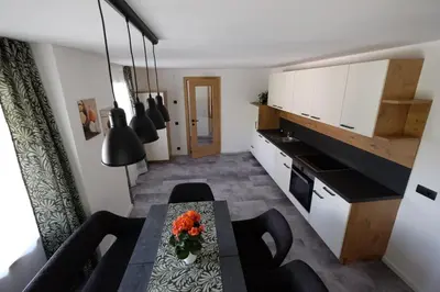 a kitchen with a table with flowers on it at Gasserhof in Campo di Trens