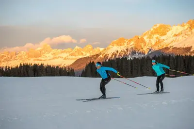 two people are skiing in the snow in the mountains at Il Nido del Picchio in Anterivo
