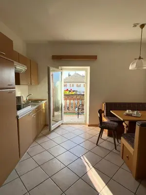 a kitchen with a table and a dining room at Il Nido del Picchio in Anterivo