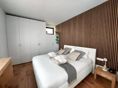 a bedroom with a large white bed with pillows at Loft del Talvera 2 in Bolzano