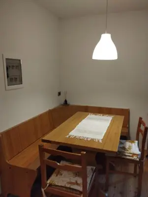 a dining room table and chairs with a light at Villa Larici piano terra in Bellamonte