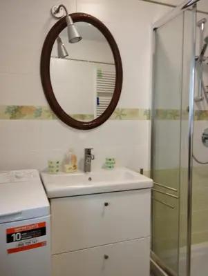 a bathroom with a sink and a mirror at Villa Larici piano terra in Bellamonte