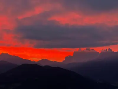 a sunset over the mountains with a red sky at Proderhof in Feldthurns