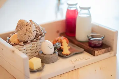 a wooden box with bread and eggs and milk at Proderhof in Feldthurns