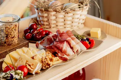 a plate of cheese and other foods on a table at Proderhof in Feldthurns