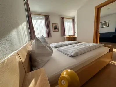 a large bed in a room with a window at Appartments Anna in Valdaora di Sotto