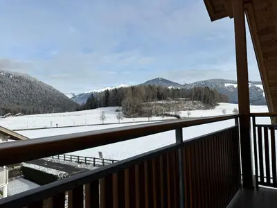 a view from a balcony of a snow covered valley at Appartments Anna in Valdaora di Sotto
