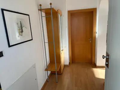 a hallway with a door and a shelf in a room at Appartments Anna in Valdaora di Sotto