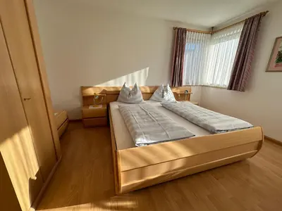 a bedroom with a large bed in a room at Appartments Anna in Valdaora di Sotto