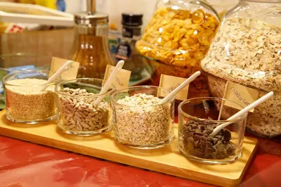 a group of glass containers filled with different types of food at Agritur Iellici in Castello di Fiemme