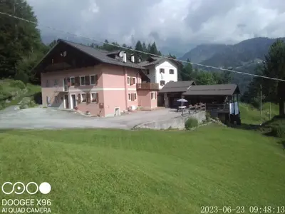 a house with a green field in front of it at B&B SòT AL PIZ in Sagron Mis