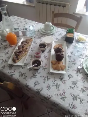 a table with three plates of food on it at B&B SòT AL PIZ in Sagron Mis