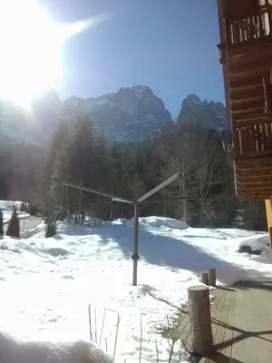 a basketball hoop in the snow with mountains in the background at B&B SòT AL PIZ in Sagron Mis