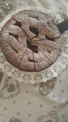 a cake on a plate with a knife on a table at B&B SòT AL PIZ in Sagron Mis