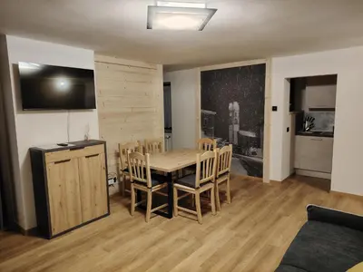 a kitchen and dining room with a table and chairs at MOUNTAIN DELUXE 27 APARTMENTS con WELLNESS in Cavalese