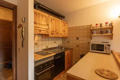 a kitchen with a sink and a microwave at Casa alla Sorgente, con vista panoramica in San Vito di Cadore
