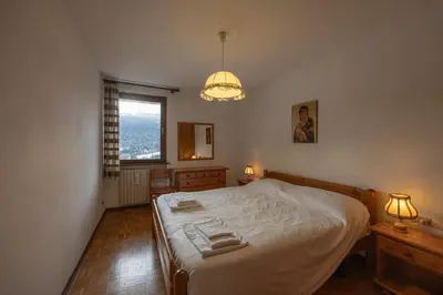 a bedroom with a bed with two towels on it at Casa alla Sorgente, con vista panoramica in San Vito di Cadore