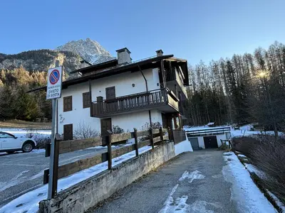a building with a balcony on the side of it at Casa alla Sorgente, con vista panoramica in San Vito di Cadore
