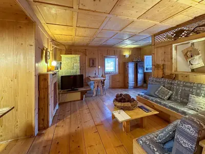 a living room with a couch and a table in a cabin at Ciasa De Doni in Pozza di Fassa