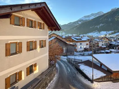 a view of a town in the snow from a building at Ciasa De Doni in Pozza di Fassa